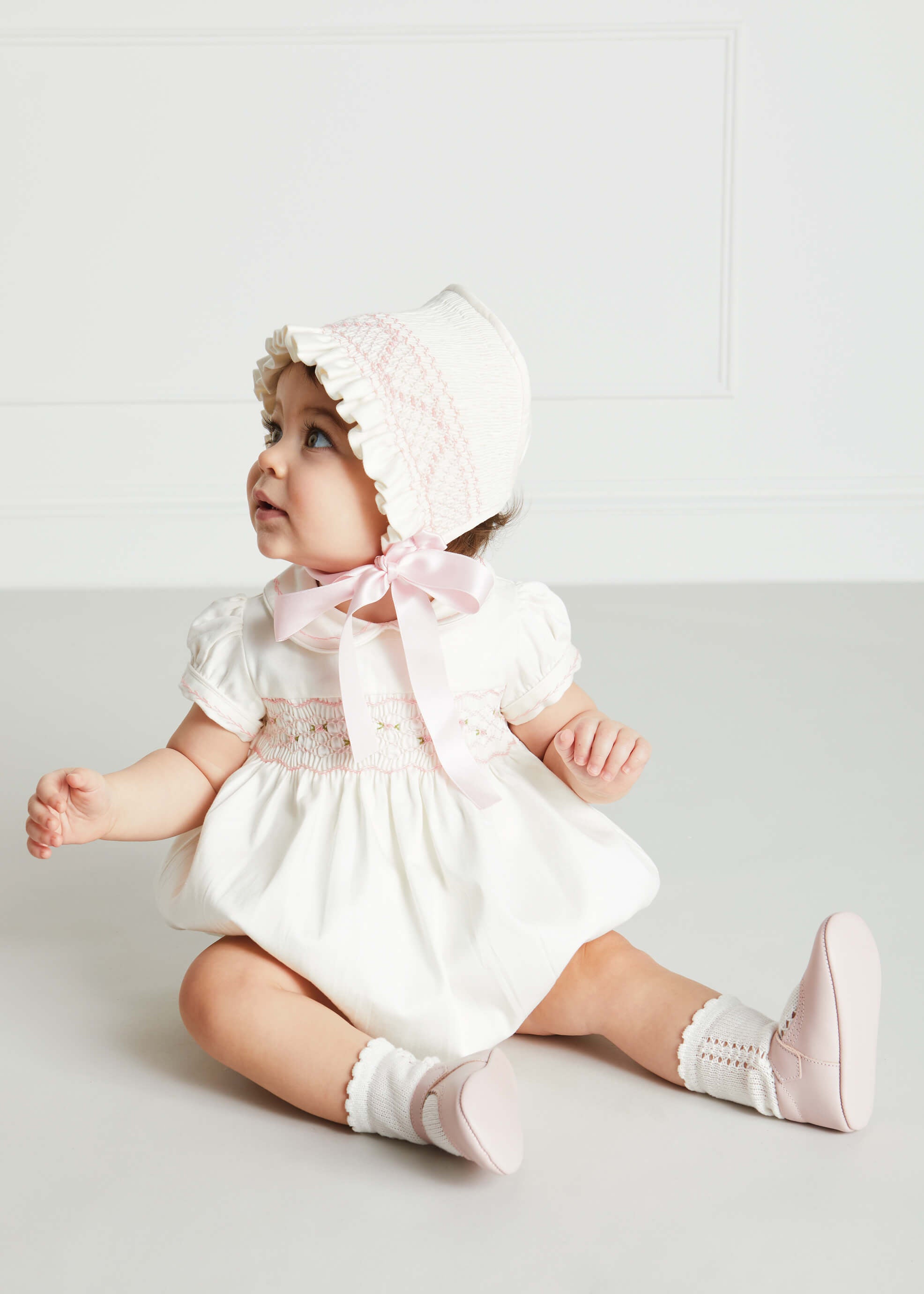 Off White and Pink Hand Smocked Baby Bonnet KNITTED ACCESSORIES from Pepa London US