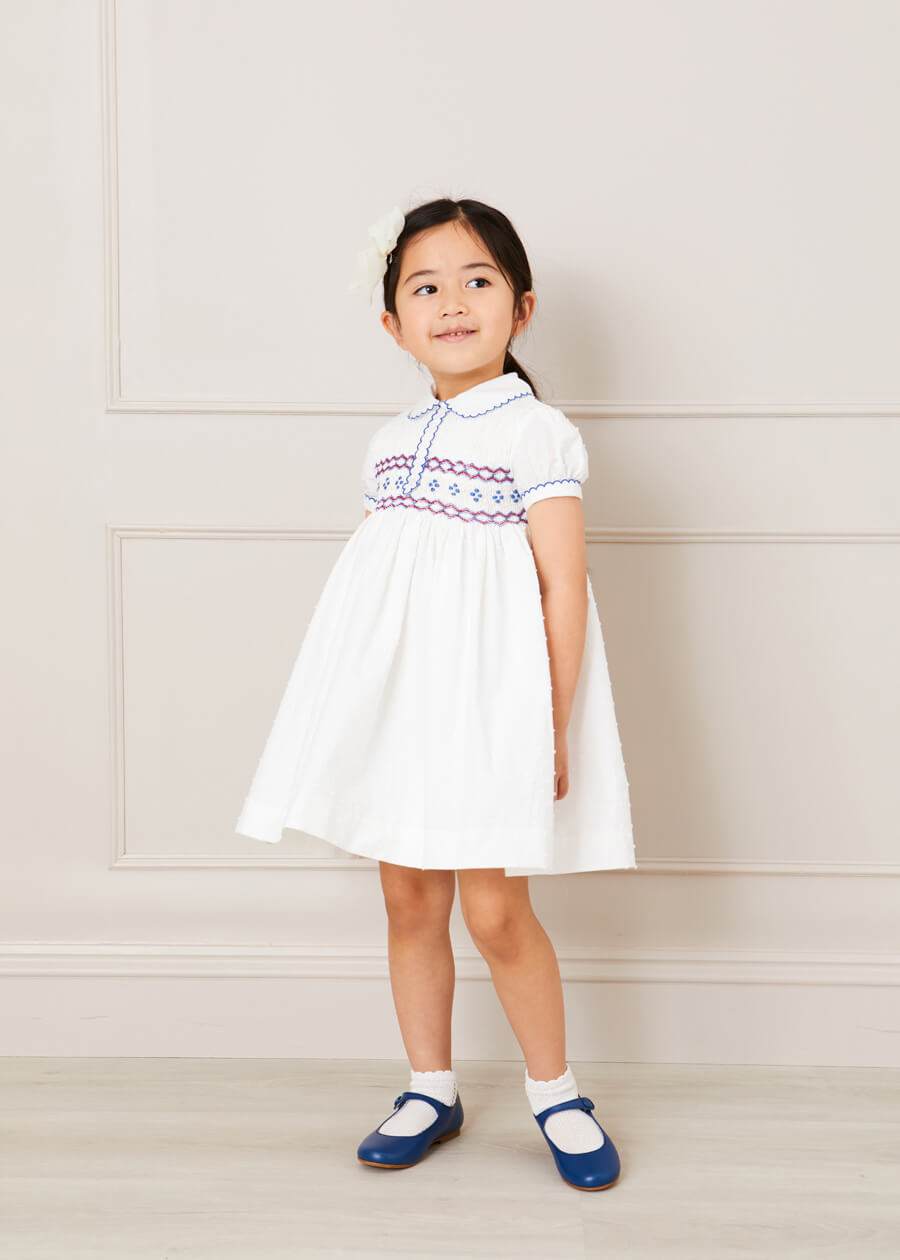 Hand Smocked Plumetti Short Sleeve Dress in White (12mths-6yrs) Dresses from Pepa London US